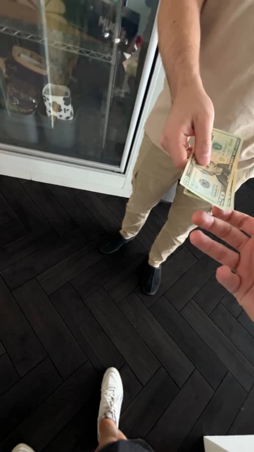 A Google review card on a shop counter, tapped with a phone (3)